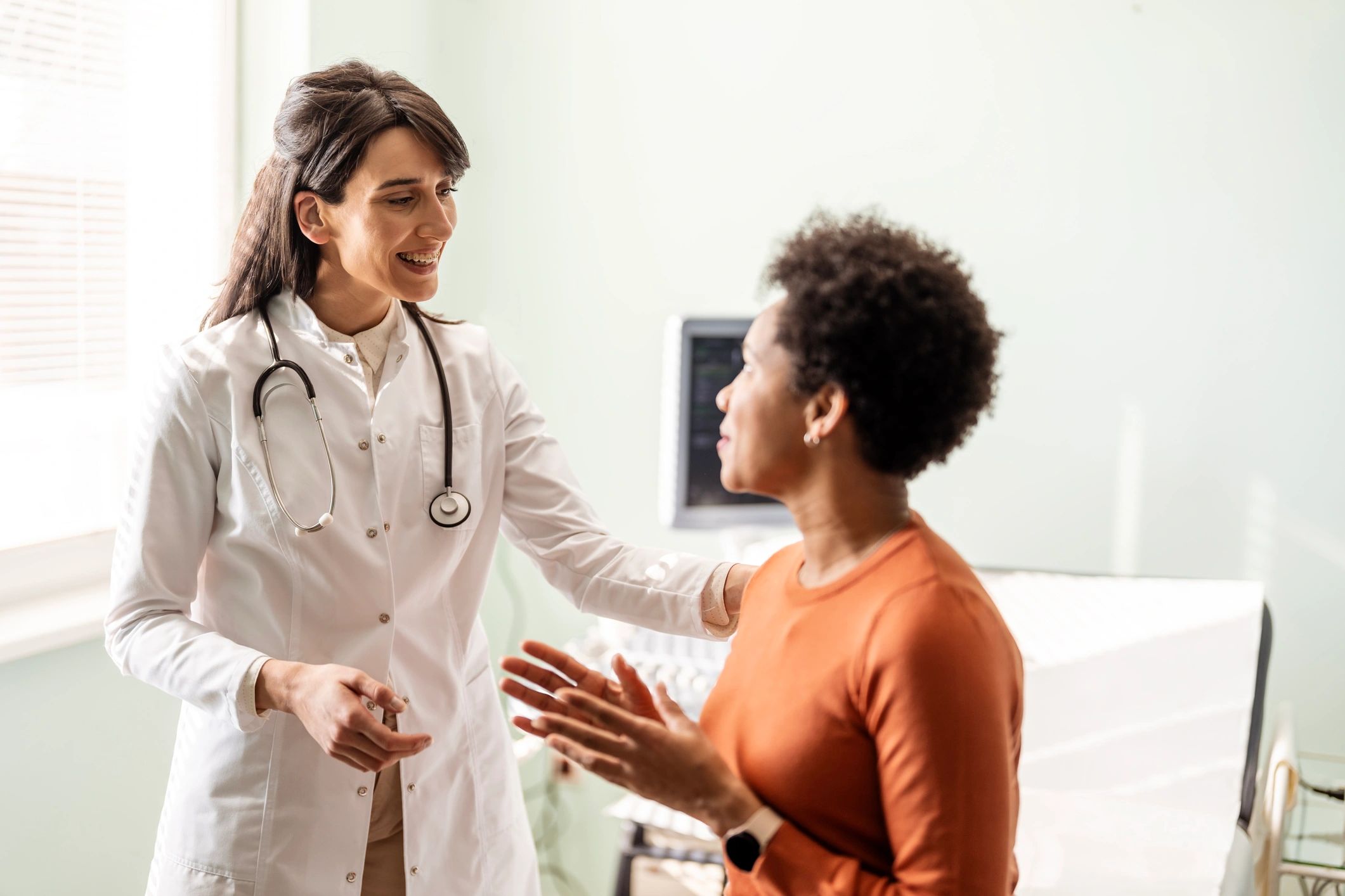 Doctor consulting with an adult patient in a clinic